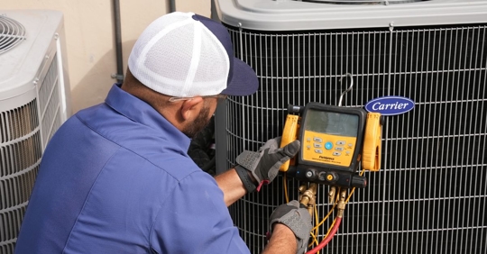 technician working on AC unit