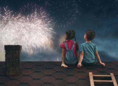 two kids on roof watching fireworks