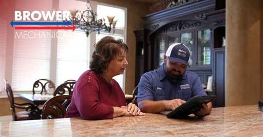 woman talking to a Brower Mechanical technician