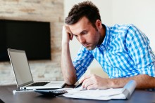 man worried and frustrated over utility bills