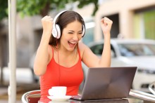 woman excited while listening to computer