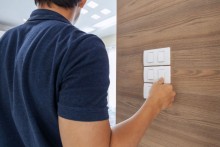 man is turning off lights to save power