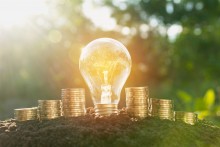 lightbulb and money, saving energy saving money concept