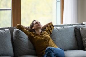 woman sitting on couch relaxing