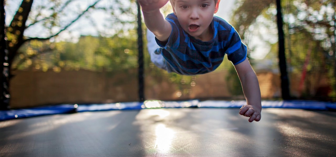 cute little boy jumping on a trampoline