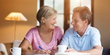 older couple planning bills over morning coffee at home