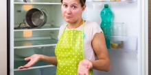 woman confused by fridge at home
