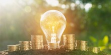 lightbulb and money, saving energy saving money concept