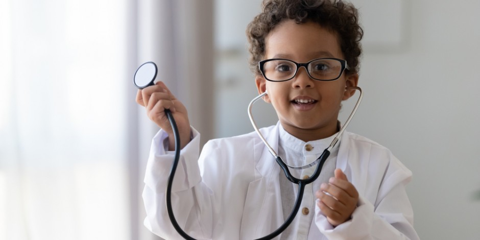 small child dressed as a doctor with stethoscope