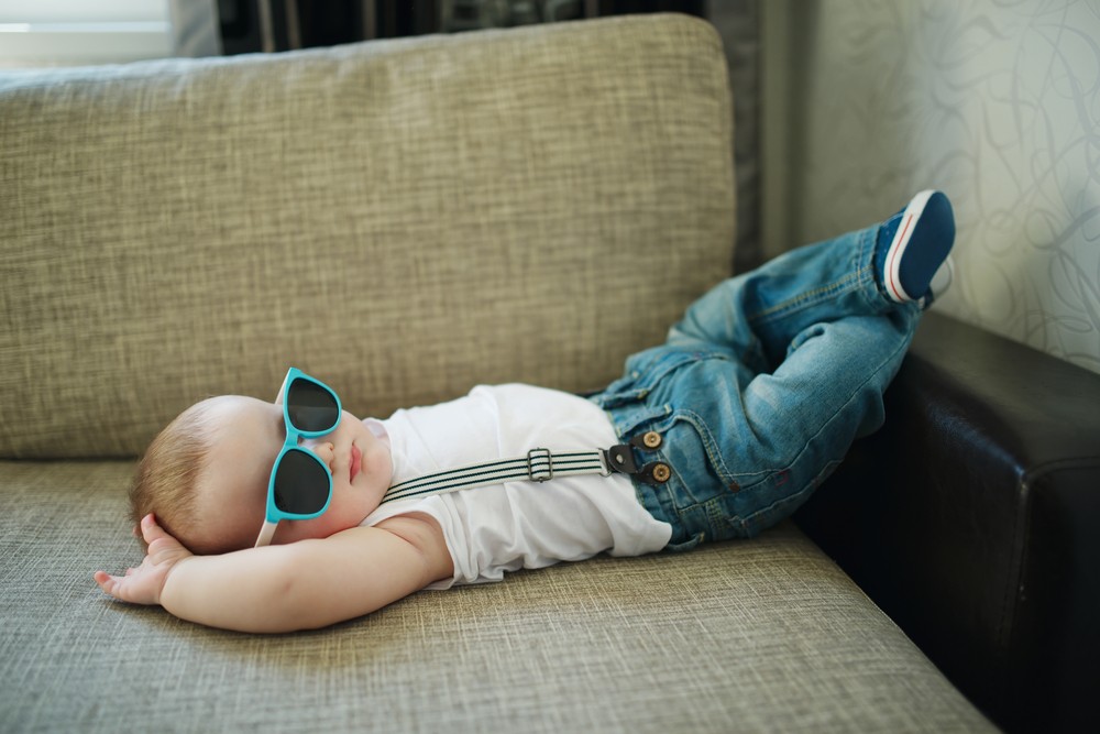 stylish baby fast asleep on couch