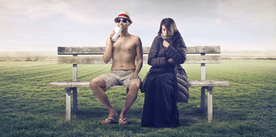 man in summer clothes sitting on bench next to woman in parka, changing seasons, hot cold concept
